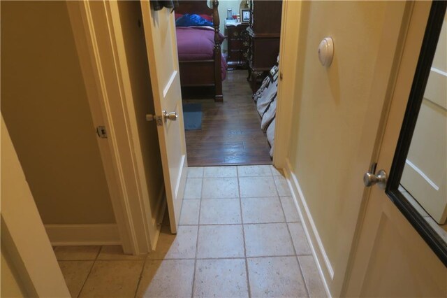 221513 James St, Jefferson, LA 70121 - corridor with baseboards and light tile patterned flooring