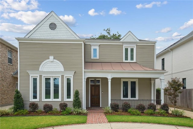 404 Atherton Dr, Metairie, LA 70005 - view of front facade featuring a standing seam roof, a porch, and metal roof