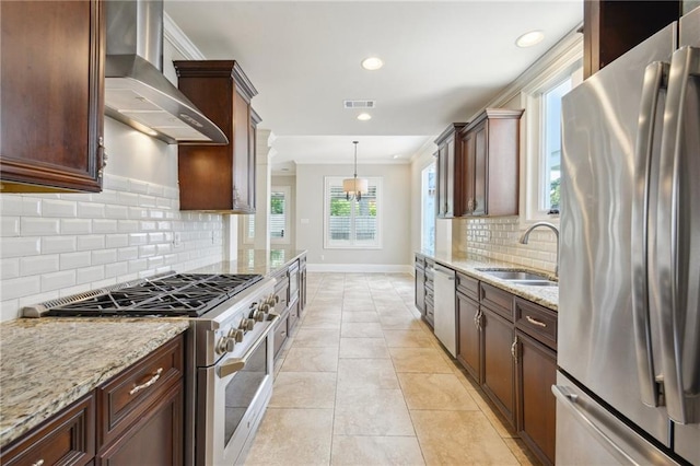 404 Atherton Dr, Metairie, LA 70005 - kitchen with appliances with stainless steel finishes, wall chimney exhaust hood, crown molding, a sink, and light stone countertops