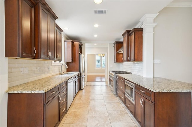 404 Atherton Dr, Metairie, LA 70005 - kitchen with appliances with stainless steel finishes, a sink, ornamental molding, decorative backsplash, and light stone counters