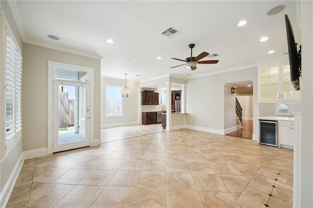 404 Atherton Dr, Metairie, LA 70005 - unfurnished living room featuring beverage cooler, crown molding, recessed lighting, baseboards, and a ceiling fan