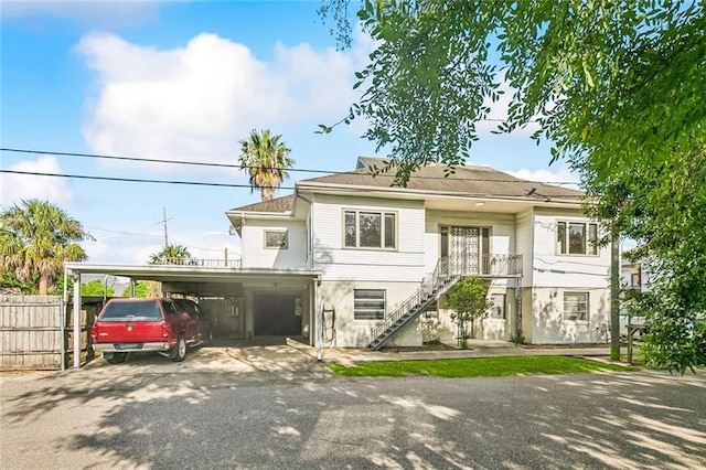 400 Aris Ave, Metairie, LA 70005 - coastal inspired home featuring a carport, driveway, and stairway