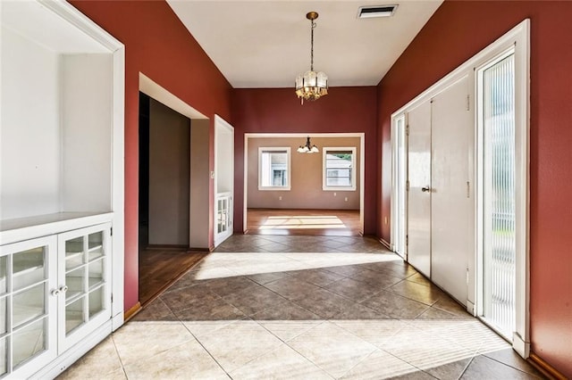 400 Aris Ave, Metairie, LA 70005 - tiled entryway featuring a chandelier and baseboards