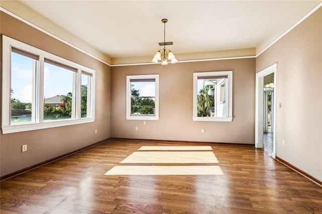 400 Aris Ave, Metairie, LA 70005 - empty room with a chandelier, wood finished floors, and baseboards
