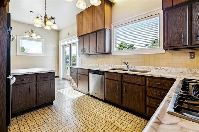 400 Aris Ave, Metairie, LA 70005 - kitchen with stainless steel appliances, a sink, light countertops, a chandelier, and dark brown cabinetry