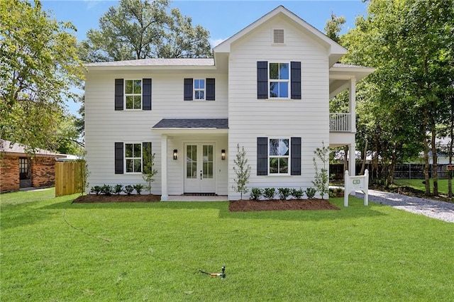 218 N Jackson Ave, Covington, LA 70433 - view of front of house featuring french doors, a balcony, and roof with shingles