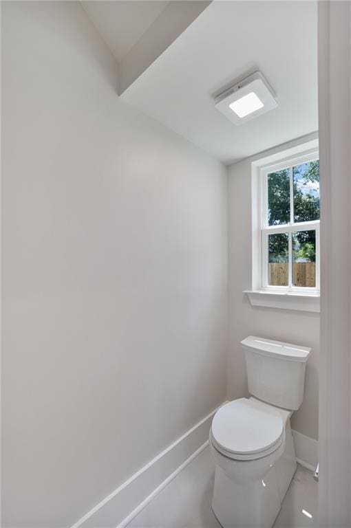 218 N Jackson Ave, Covington, LA 70433 - bathroom featuring baseboards and toilet
