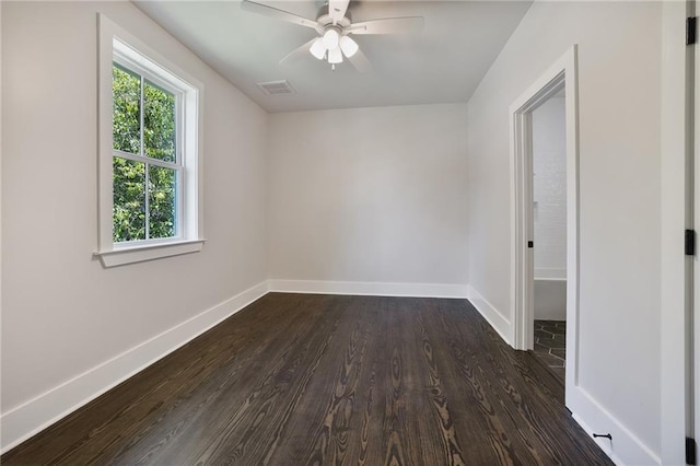 218 N Jackson Ave, Covington, LA 70433 - unfurnished room featuring dark wood-style flooring, a ceiling fan, and baseboards