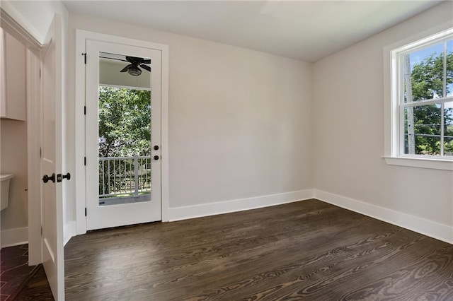 218 N Jackson Ave, Covington, LA 70433 - unfurnished room featuring dark wood-style floors, baseboards, and a ceiling fan