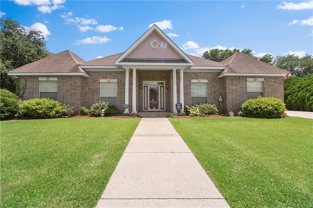 135 Maud Olive Dr, Belle Chasse, LA 70037 - neoclassical / greek revival house with a front lawn, brick siding, and a shingled roof
