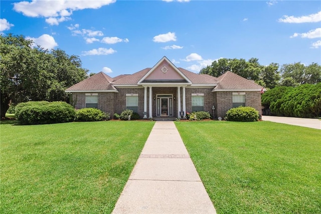 135 Maud Olive Dr, Belle Chasse, LA 70037 - neoclassical / greek revival house with a front yard and brick siding