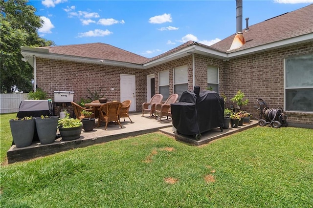 135 Maud Olive Dr, Belle Chasse, LA 70037 - rear view of house with brick siding, a patio, a garage, and roof with shingles