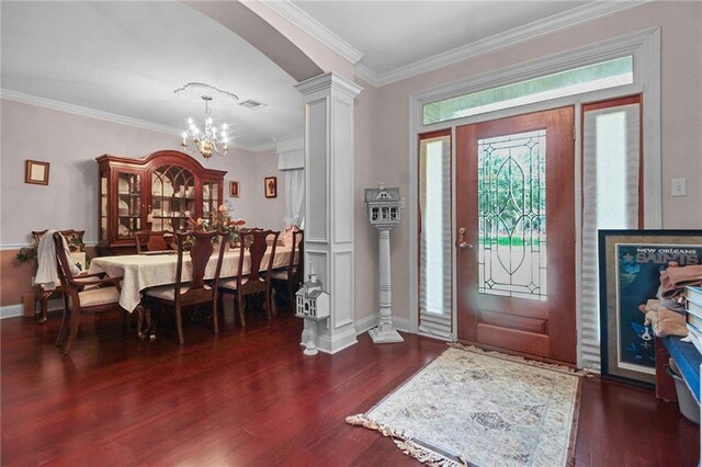 135 Maud Olive Dr, Belle Chasse, LA 70037 - entrance foyer with a chandelier, decorative columns, wood finished floors, crown molding, and arched walkways