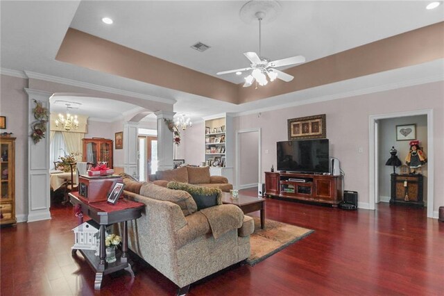 135 Maud Olive Dr, Belle Chasse, LA 70037 - living area with a chandelier, arched walkways, ornate columns, ceiling fan, and wood finished floors