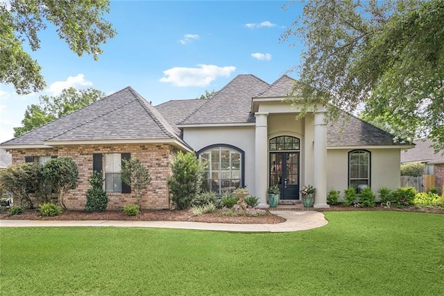 436 Northpark Blvd, Covington, LA 70433 - view of front of home featuring roof with shingles, a front yard, stucco siding, french doors, and brick siding