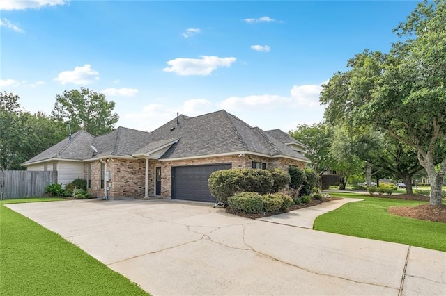 436 Northpark Blvd, Covington, LA 70433 - view of front of house with brick siding, an attached garage, driveway, and roof with shingles
