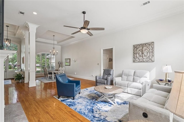 436 Northpark Blvd, Covington, LA 70433 - living room featuring decorative columns, ornamental molding, wood finished floors, ceiling fan, and a chandelier