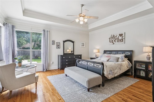 436 Northpark Blvd, Covington, LA 70433 - bedroom with a tray ceiling, wood finished floors, ornamental molding, and a ceiling fan
