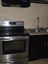 2543-45 Gravier St, New Orleans, LA 70119 - kitchen featuring stainless steel range with electric stovetop, extractor fan, and a sink