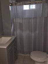 2543-45 Gravier St, New Orleans, LA 70119 - full bath with toilet, vanity, tile patterned flooring, and a shower with shower curtain