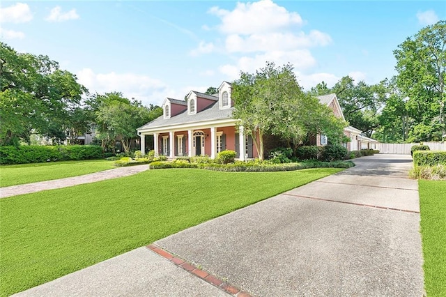 9816 Elm Pl, River Ridge, LA 70123 - cape cod-style house with a front yard and a porch