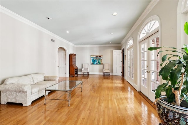 9816 Elm Pl, River Ridge, LA 70123 - living room featuring arched walkways, healthy amount of natural light, light wood-style flooring, recessed lighting, and ornamental molding