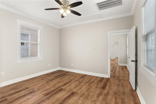 2718 Palmyra St, New Orleans, LA 70119 - spare room featuring ornamental molding, wood finished floors, baseboards, a ceiling fan, and attic access
