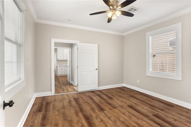 2718 Palmyra St, New Orleans, LA 70119 - unfurnished bedroom with multiple windows, wood finished floors, ornamental molding, baseboards, and a ceiling fan