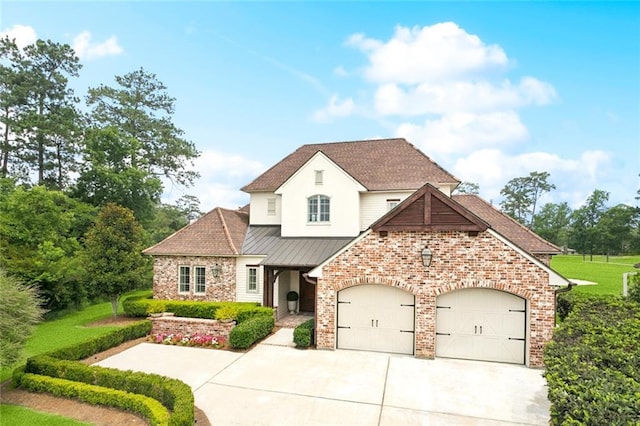 28 Wax Myrtle Ln, Covington, LA 70433 - french country style house with driveway, a garage, a standing seam roof, brick siding, and roof with shingles