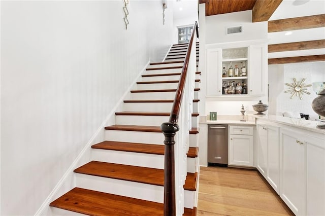 28 Wax Myrtle Ln, Covington, LA 70433 - stairs with wood finished floors, bar area, and beamed ceiling