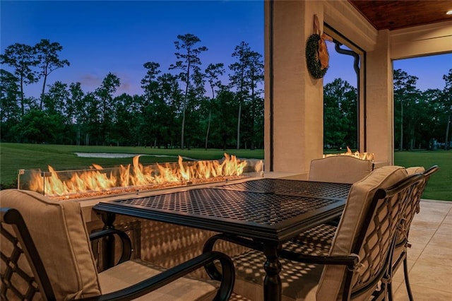 28 Wax Myrtle Ln, Covington, LA 70433 - view of patio featuring an outdoor fire pit, outdoor dining space, and view of scattered trees