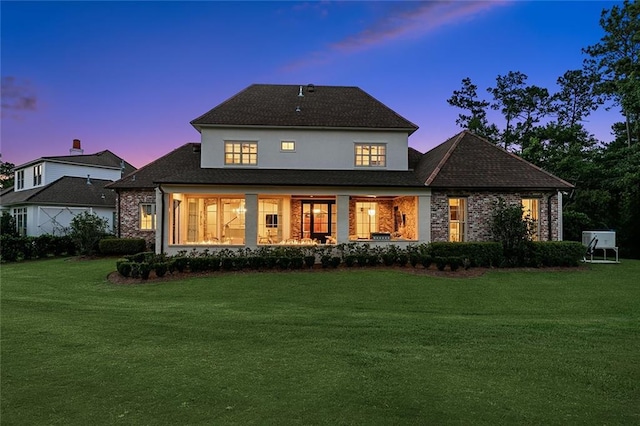 28 Wax Myrtle Ln, Covington, LA 70433 - back of house at dusk with a lawn and brick siding