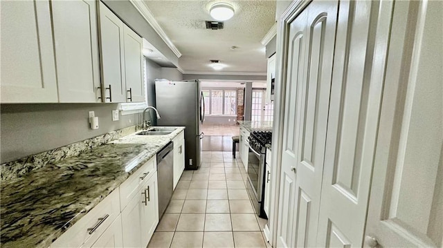1813 Green Oak Dr, Gretna, LA 70056 - kitchen with ornamental molding, stainless steel appliances, a textured ceiling, white cabinets, and light stone countertops