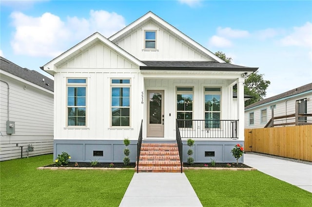5516 Warrington Dr, New Orleans, LA 70122 - modern farmhouse with board and batten siding and a porch