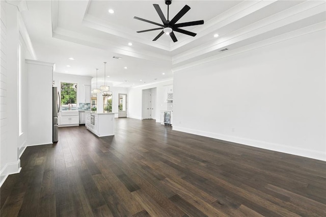5516 Warrington Dr, New Orleans, LA 70122 - unfurnished living room with a tray ceiling, recessed lighting, a ceiling fan, dark wood-style flooring, and baseboards