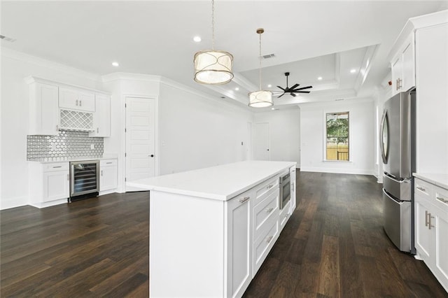 5516 Warrington Dr, New Orleans, LA 70122 - kitchen featuring beverage cooler, stainless steel appliances, ornamental molding, a raised ceiling, and white cabinets