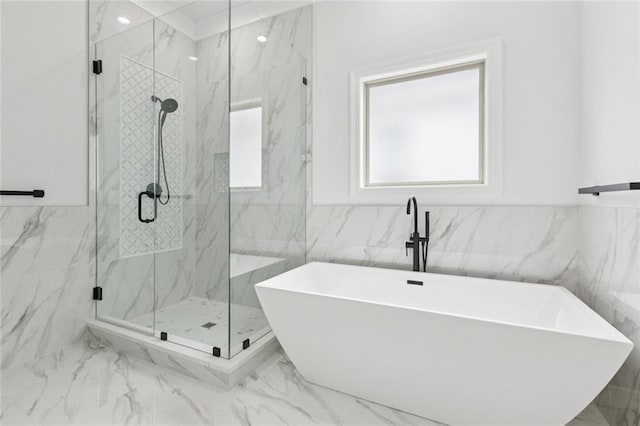 5516 Warrington Dr, New Orleans, LA 70122 - bathroom featuring tile walls, marble finish flooring, a soaking tub, and a marble finish shower