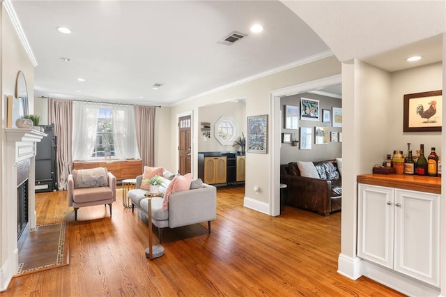 6035 Louis Xiv St, New Orleans, LA 70124 - living room with ornamental molding, light wood-style floors, a fireplace, recessed lighting, and baseboards
