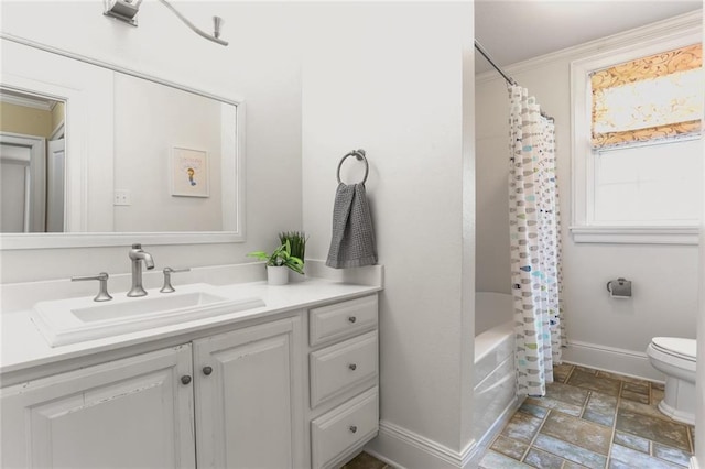 6035 Louis Xiv St, New Orleans, LA 70124 - bathroom featuring stone finish floors, vanity, toilet, baseboards, and shower / bath combo