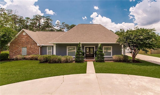 42251 Jefferson Dr, Hammond, LA 70403 - view of front facade with a front yard, french doors, stucco siding, and a porch