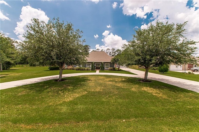 42251 Jefferson Dr, Hammond, LA 70403 - view of property hidden behind natural elements with curved driveway and a front yard