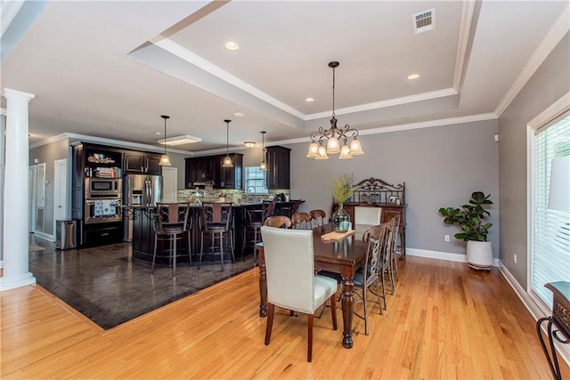 42251 Jefferson Dr, Hammond, LA 70403 - dining space with decorative columns, plenty of natural light, light wood-type flooring, crown molding, and recessed lighting