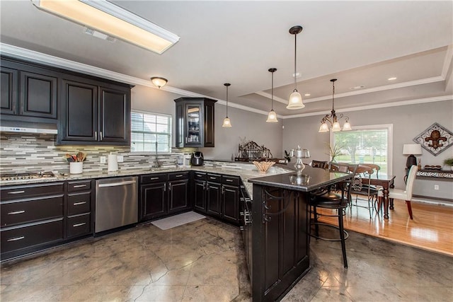 42251 Jefferson Dr, Hammond, LA 70403 - kitchen with appliances with stainless steel finishes, a raised ceiling, a breakfast bar area, a peninsula, and tasteful backsplash