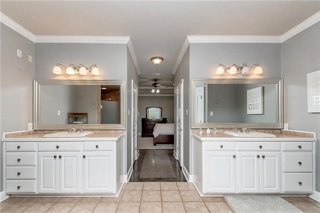 42251 Jefferson Dr, Hammond, LA 70403 - bathroom featuring ornamental molding, ceiling fan, two vanities, baseboards, and connected bathroom