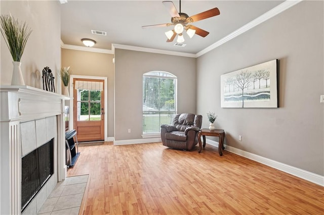 70323 11th St, Covington, LA 70433 - living area with light wood-style floors, healthy amount of natural light, baseboards, crown molding, and ceiling fan