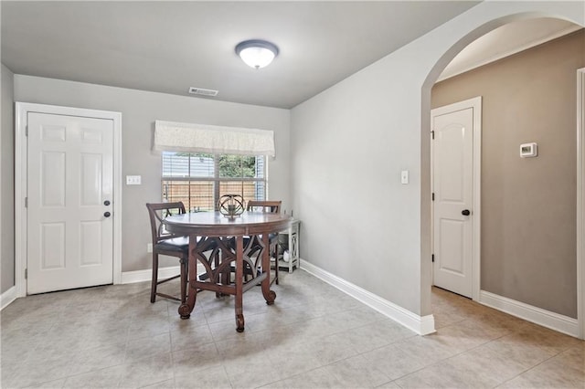 70323 11th St, Covington, LA 70433 - dining space with arched walkways, baseboards, and light tile patterned flooring