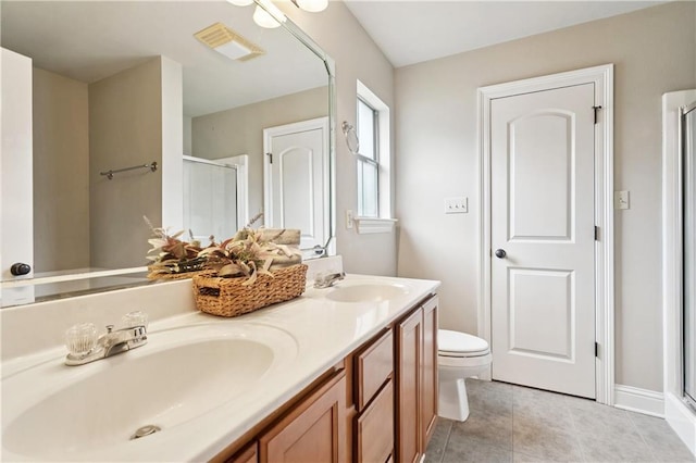 70323 11th St, Covington, LA 70433 - bathroom with a shower stall, double vanity, tile patterned floors, and toilet