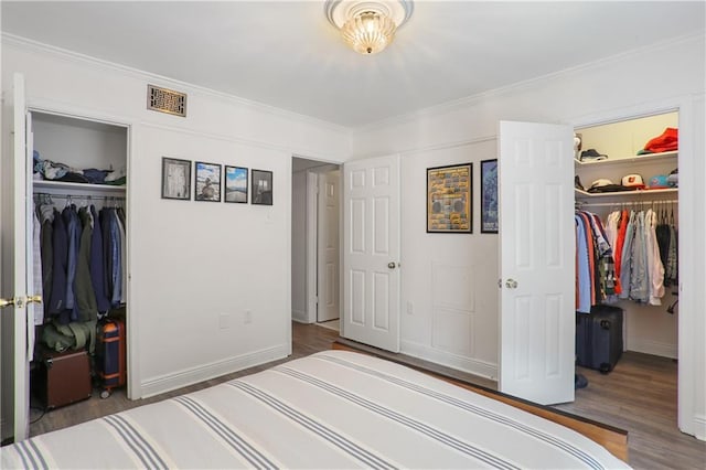 732 Cherokee St Unit 305, New Orleans, LA 70118 - unfurnished bedroom with a closet, a walk in closet, wood finished floors, and crown molding