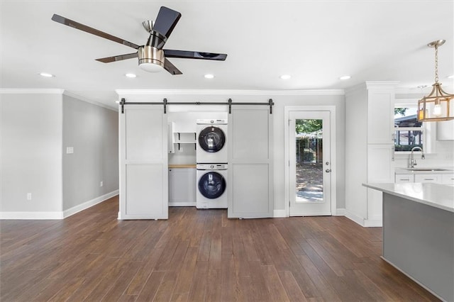 2308 Taft Park, Metairie, LA 70001 - washroom featuring stacked washer / dryer, a barn door, baseboards, crown molding, and recessed lighting