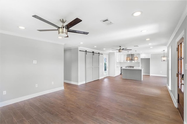2308 Taft Park, Metairie, LA 70001 - unfurnished living room featuring a ceiling fan, a barn door, ornamental molding, recessed lighting, and baseboards